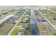 This aerial perspective shows the layout of a community with canal-front homes, emphasizing the waterfront lifestyle at 235 Tournament Rd, Rotonda West, FL 33947