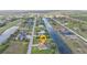 Aerial view of home with a beautiful backyard on a waterfront street in a residential neighborhood at 235 Tournament Rd, Rotonda West, FL 33947