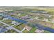 An aerial view shows the community's layout, showcasing homes, a canal, and the community's proximity to natural areas at 235 Tournament Rd, Rotonda West, FL 33947