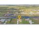 Wide aerial view of a home with a beautiful backyard on a waterfront street in a residential neighborhood at 235 Tournament Rd, Rotonda West, FL 33947