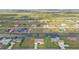 A scenic aerial view of homes in a waterfront community, highlighting canals, green spaces, and some screened-in pools at 235 Tournament Rd, Rotonda West, FL 33947