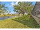 Expansive backyard with lush grass and water view, providing a serene and private outdoor space at 235 Tournament Rd, Rotonda West, FL 33947