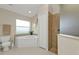 Bathroom with a shower, a tub next to the window, and a toilet at 235 Tournament Rd, Rotonda West, FL 33947