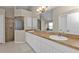 Spacious bathroom with double sinks, a shower, a large mirror, and white cabinets at 235 Tournament Rd, Rotonda West, FL 33947