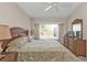 Bedroom featuring a decorative bed, ceiling fan, dresser, and lots of light at 235 Tournament Rd, Rotonda West, FL 33947