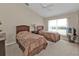 Cozy bedroom with two twin beds, a ceiling fan, and natural light from a large window at 235 Tournament Rd, Rotonda West, FL 33947