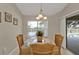 Bright breakfast nook with glass table, rattan chairs, and natural light at 235 Tournament Rd, Rotonda West, FL 33947