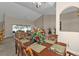 Inviting dining area with natural light, dining table seating for six, and an open view to the living room at 235 Tournament Rd, Rotonda West, FL 33947