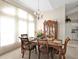 Formal dining room with natural light, traditional-style furniture, and decorative hutch at 235 Tournament Rd, Rotonda West, FL 33947
