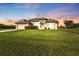 Charming single-story home with a lush green lawn and well-maintained landscaping at 235 Tournament Rd, Rotonda West, FL 33947