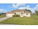 Inviting one-story home with a well-kept lawn and charming landscaping at 235 Tournament Rd, Rotonda West, FL 33947