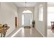 Bright foyer with tiled flooring, high ceilings, and a decorative pendant light fixture above the front door at 235 Tournament Rd, Rotonda West, FL 33947