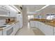 Well-lit kitchen with ample counter space, white appliances, and adjacent dining area at 235 Tournament Rd, Rotonda West, FL 33947