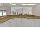 This kitchen features lots of counterspace and a large, stainless steel sink at 235 Tournament Rd, Rotonda West, FL 33947