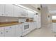 Bright kitchen featuring white appliances and ample counter space for cooking at 235 Tournament Rd, Rotonda West, FL 33947