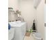 Practical laundry room with washer, dryer, and storage shelving for convenience at 235 Tournament Rd, Rotonda West, FL 33947