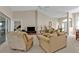 Open living room with neutral decor, vaulted ceiling, and seamless flow to the outdoor screened-in lanai at 235 Tournament Rd, Rotonda West, FL 33947