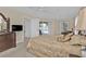 Main bedroom featuring carpet, a ceiling fan, and sliding doors to an outdoor pool area at 235 Tournament Rd, Rotonda West, FL 33947