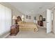 Main bedroom with dresser, ceiling fan, neutral colors, and a door to the bathroom at 235 Tournament Rd, Rotonda West, FL 33947