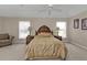 Large main bedroom with two windows, a ceiling fan, and carpet flooring at 235 Tournament Rd, Rotonda West, FL 33947