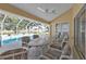 Screened patio with dining table and chairs near a pool and waterfront view at 235 Tournament Rd, Rotonda West, FL 33947