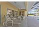 Covered patio with ample seating options, a pool, and screened enclosure at 235 Tournament Rd, Rotonda West, FL 33947
