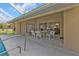 Outdoor patio area with dining furniture, ideal for enjoying meals by the pool and lounging at 235 Tournament Rd, Rotonda West, FL 33947