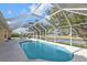 Relaxing screened pool with a view of the tranquil pond at 235 Tournament Rd, Rotonda West, FL 33947
