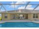 Backyard pool area with a patio dining set and waterfront view at 235 Tournament Rd, Rotonda West, FL 33947