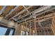 Exposed ceiling framing showcasing the unique design and new construction features, with window views at 242 Bangsberg Se Rd, Port Charlotte, FL 33952