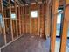 Unfinished interior showcasing framing with electrical elements, offering a glimpse into the building phase of a modern home at 242 Bangsberg Se Rd, Port Charlotte, FL 33952
