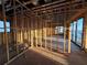 Interior wood framing with windows offering water views, awaiting finishing touches for a waterfront home at 242 Bangsberg Se Rd, Port Charlotte, FL 33952