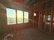 View of interior framing with a large picture window showcasing a picturesque landscape at sunset at 242 Bangsberg Se Rd, Port Charlotte, FL 33952