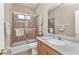Cozy bathroom featuring a shower-tub combo, vanity sink, and coastal-themed decor at 24260 Westgate Blvd, Port Charlotte, FL 33980