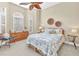 A relaxing bedroom with a decorative ceiling fan, natural light and earth tone colors at 24260 Westgate Blvd, Port Charlotte, FL 33980