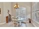 Bright breakfast nook with white table, shuttered windows, and elegant chandelier at 24260 Westgate Blvd, Port Charlotte, FL 33980