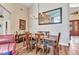 Elegant dining room with a large wooden table, chandelier, and a mirror on the wall at 24260 Westgate Blvd, Port Charlotte, FL 33980