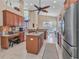 A gourmet kitchen boasts stainless steel appliances, granite counters, wood cabinets, and ample counter space at 24260 Westgate Blvd, Port Charlotte, FL 33980