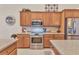 A lovely kitchen with stainless steel appliances, wooden cabinets, and granite countertops at 24260 Westgate Blvd, Port Charlotte, FL 33980