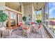 This screened lanai features brick pavers, a ceiling fan and beautiful views through the glass windows at 24260 Westgate Blvd, Port Charlotte, FL 33980
