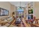 The living room is open and airy with a fireplace, high ceilings, and sliding doors to the lanai at 24260 Westgate Blvd, Port Charlotte, FL 33980