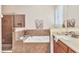 Main bathroom showcases a soaking tub, tiled shower, and stylish fixtures at 24260 Westgate Blvd, Port Charlotte, FL 33980