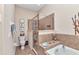 Tiled main bathroom featuring a walk-in shower and a separate soaking tub at 24260 Westgate Blvd, Port Charlotte, FL 33980