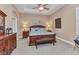 Well-lit main bedroom with trey ceiling, a ceiling fan, carpet floors, and stylish furnishings at 24260 Westgate Blvd, Port Charlotte, FL 33980