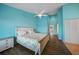 Brightly painted primary bedroom boasts a ceiling fan, shuttered windows, and wood-look floors at 25188 Marion Ave # 1033, Punta Gorda, FL 33950
