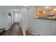 Bright entryway featuring hardwood floors, neutral walls, and seamless access to the kitchen at 25188 Marion Ave # 1033, Punta Gorda, FL 33950