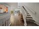 Inviting entryway featuring hardwood floors, staircase, and seamless flow into the living spaces at 25188 Marion Ave # 1033, Punta Gorda, FL 33950