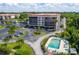 A beautiful condominium building sits next to the community pool, palm trees, and bayou at 25188 Marion Ave # 1033, Punta Gorda, FL 33950