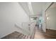 Upstairs hallway boasts white walls, wood-look floors and access to a washer and dryer at 25188 Marion Ave # 1033, Punta Gorda, FL 33950