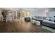 Open-concept living space with hardwood floors, comfortable seating, and access to outdoor views at 25188 Marion Ave # 1033, Punta Gorda, FL 33950